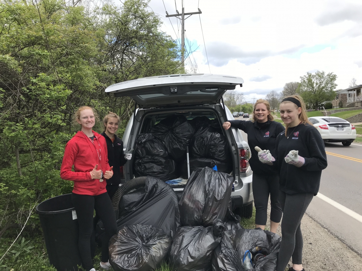 Students with garage bags